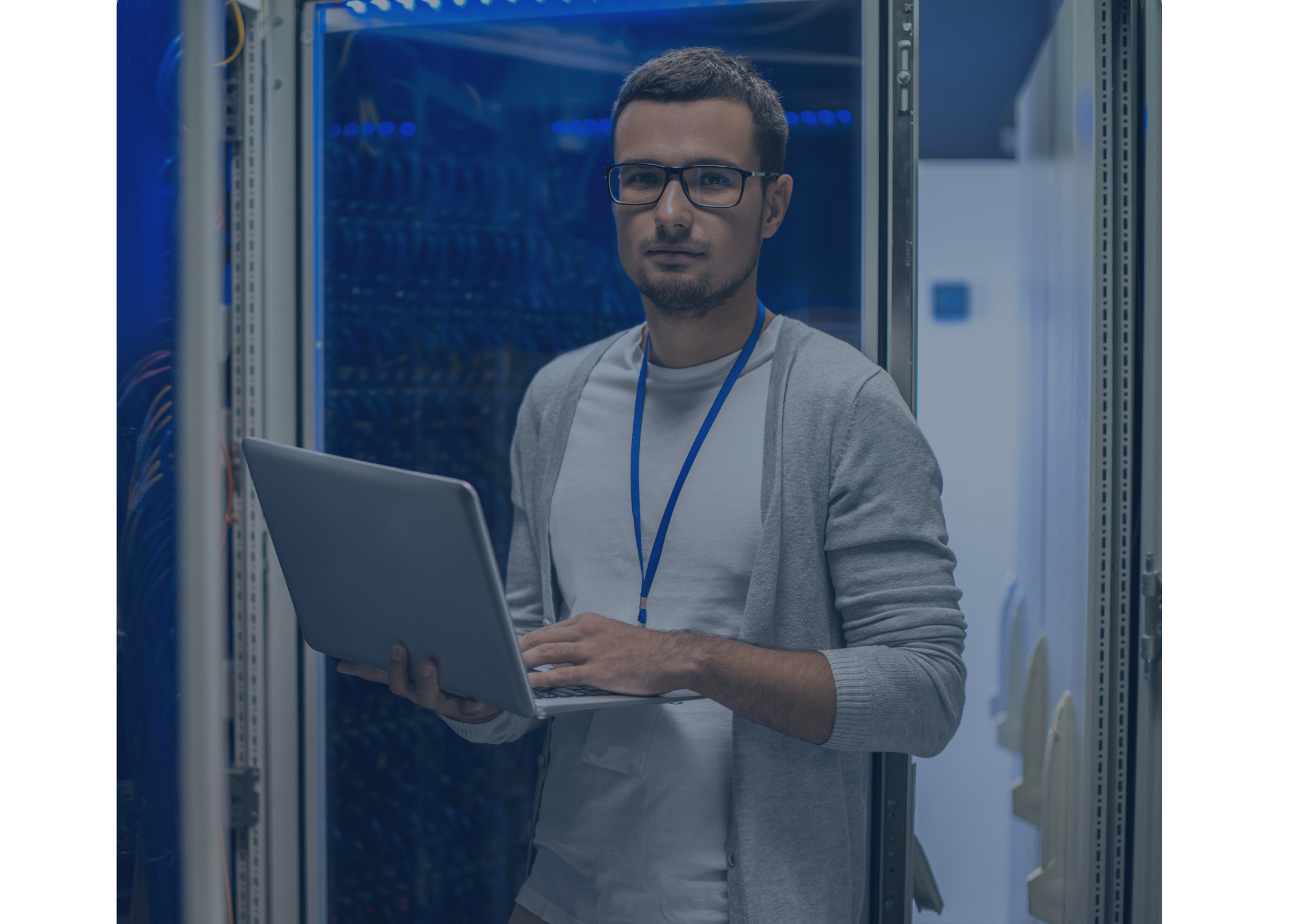 Man in front of server room with laptop